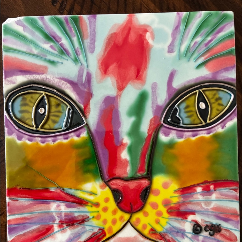 Ceramic tile by Claudia Sanchez (CGS) featuring a colorful cat face.